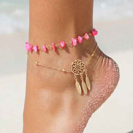 goudkleurig-enkelbandje-met-roze-steentjes-en-drom (1)